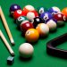 The composition of billiard balls on a table made dSLR. Triangle, balls and sticks and elements to the game of billiards. The picture was taken in a horizontal orientation