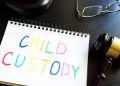 Child custody written in a note and gavel. Separation concept