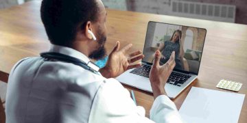telepsychiatry - doctor advising patient online with laptop