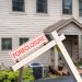 Mockup of a foreclosure sign in front of a modern townhome or townhouse to illustrate recession fears due to coronavirus