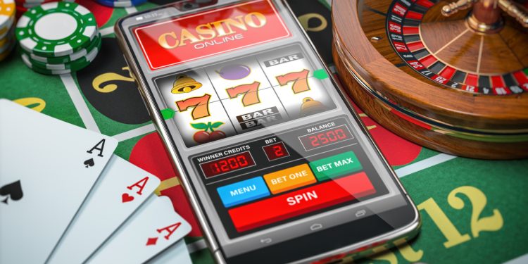 Casino online. Smartphone or mobile phone, slot machine, dice, cards and roulette on a green table in casino. 3d illustration